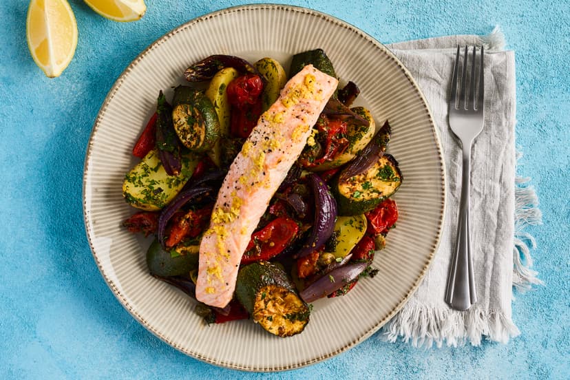 Sometimes, less is more. A little lemon zest is enough to make salmon fillets sing in this light and lovely fish dish. Youʼll cut down on washing-up, too, by roasting the salmon on top of the Med veg and capers. A serving of herby baby potatoes ensures this meal is as satisfying as it is delicious.