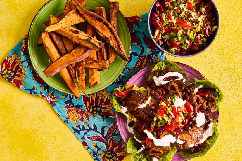 Easy enough for midweek, but with enough fun factor for Friday night, you’ll love these lightened-up fajitas. Juicy strips of spiced steak and freshly sizzled pepper, onion and black beans are wrapped up in crunchy lettuce leaves, smothered with scrummy salsa, drizzled with zesty yogurt and served with chunky wedges.