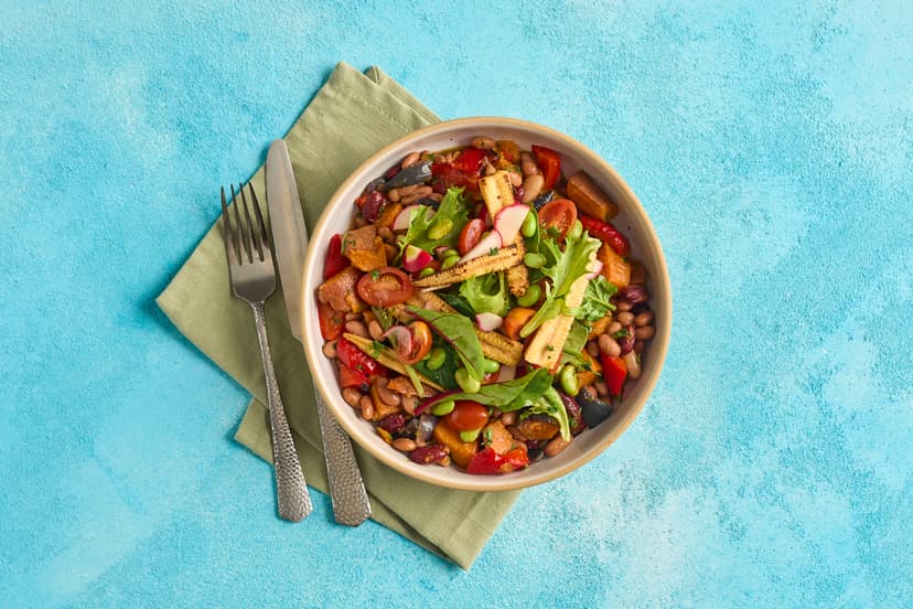 This vibrant, plant-based bowlful is spring/summer ready! Roasted sweet potato, red pepper and red onion wedges team up with garlicky, herby mixed beans, charred baby corn and edamame, and a radish and tomato salad. It takes ‘eating the rainbow’ to the next level.