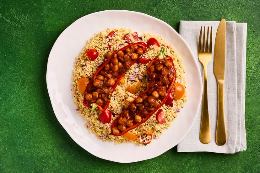 They say life’s too short to stuff a mushroom – but it’s definitely worth taking the time to stuff these peppers! Harissa is a North African mix of chilli, garlic and warming spices. Here, it gives a flavour boost to chickpeas packed into roasted red peppers and served with minty, tomato-dressed couscous.