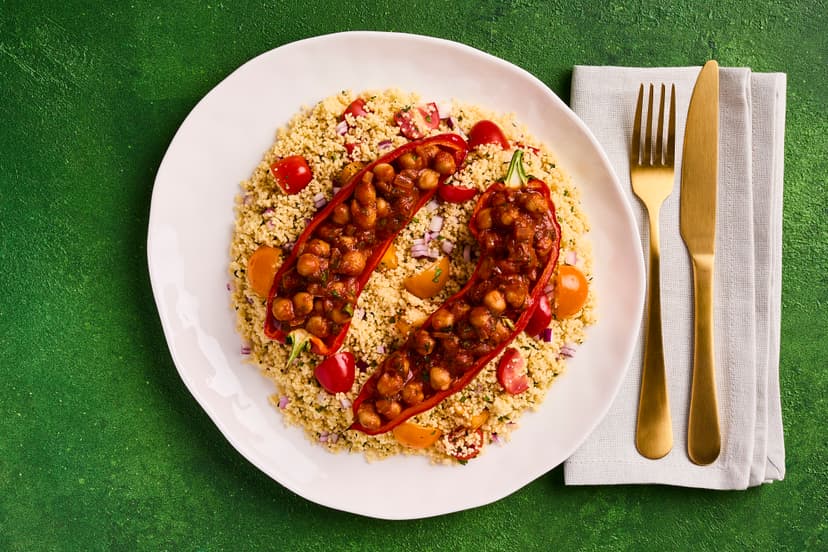 They say life’s too short to stuff a mushroom – but it’s definitely worth taking the time to stuff these peppers! Harissa is a North African mix of chilli, garlic and warming spices. Here, it gives a flavour boost to chickpeas, which are then packed into roasted red peppers and served with couscous thatʼs dressed up with tomatoes, mint and red onion.