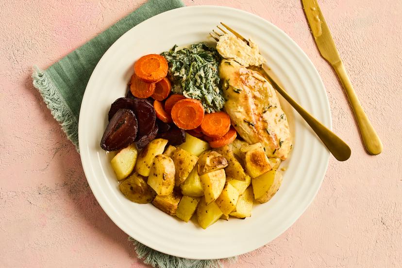 It’s chicken tonight, but with a little added ‘je ne sais quoiʼ. Searing then simmering chicken breasts in a garlic, lemon and thyme stock keeps them beautifully tender and juicy, and they’re divine served with roasted carrots, beetroot and potatoes and our lightened-up take on creamed spinach. Bon appétit!