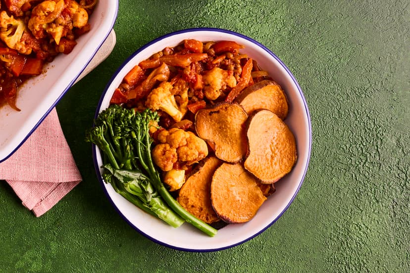 Cauli-power up your midweek menu with this spicy, satisfying sensation. Cauliflower florets are simmered in a Thai red curry-style sauce with chunks of carrot, slivers of red pepper and green lentils, covered with crispy sweet potato slices and served with a side of tender broccoli.