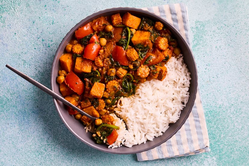 Sweet potato and chickpeas are a perfect marriage, absorbing the flavours of this rich and spicy tomato sauce beautifully. Mixed with onion, red pepper and baby corn, served with basmati rice flecked with spinach and coriander, it’s curry heaven.