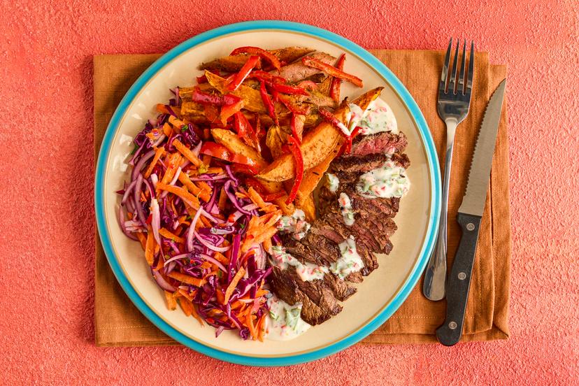 We’re heading for America’s deep south with this Cajun feast. Bavette steak (the butcher’s favourite cut!) is fried with our special spice blend and served with golden potato wedges, a vibrant slaw and zippy yogurt dressing with chilli and lime.