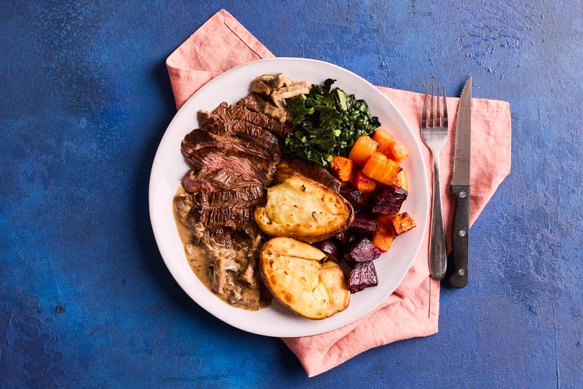 Raise the steaks at dinnertime with this autumnal feast. Bavette steak (known as the butcher’s cut) is flash fried and served with cavolo nero and roast potatoes, carrots and beets, with a garlicky mushroom and shallot sauce. Crushing the potatoes halfway through roasting gives a gorgeous crispy finish.