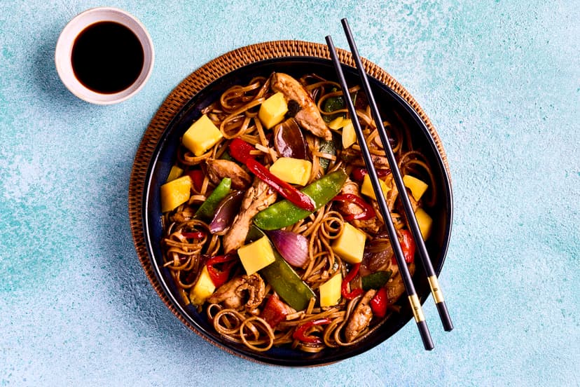 Fresh ginger, garlic and spring onions are known as the ‘holy trinityʼ of Chinese cooking. In this heavenly stir-fry, they’re sizzled with chicken strips, pepper, onion and mangetout, a dash of oyster sauce and a hint of chilli, served on noodles and sprinkled with mango chunks and more chilli.