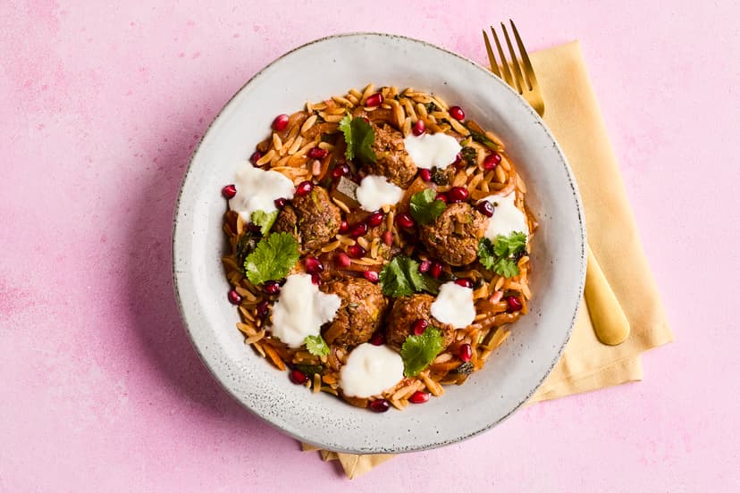 Italy meets Morocco in this fabulous fusion of flavours. Beef and courgette meatballs nestle in a veg-packed tomato sauce, lightly spiced with harissa paste, topped with a sprinkle of coriander and pomegranate seeds and finished with yogurt, while orzo pasta provides the filling power.