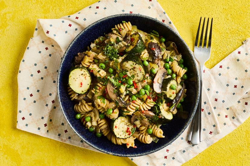 Roasting the courgettes adds lovely depth of flavour to this hearty and wholesome dish. They team up with leeks, mushrooms and peas and a hint of chilli, stirred through spirals of girandole pasta to soak up the garlicky, herby sauce and finished with a sprinkling of parsley. Yummy!