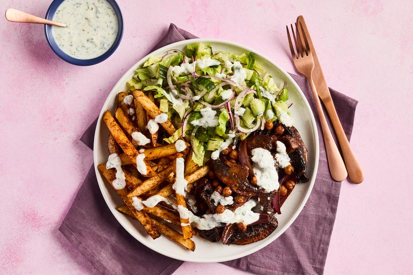 Transport yourself to the Greek islands with this chickpea and mushroom medley, in a fragrant tomato sauce. It’s served with skinny fries spiked with paprika and oregano, and a refreshing green salad, drizzled with garlicky, herby yogurt.