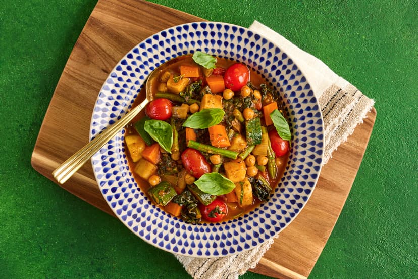 Imagine a hug in a bowl and this is it! In this rustic dish – a halfway house between a stew and a broth – a cornucopia of veg (potato, carrot, courgette, green beans, cavolo nero and tomatoes) is cooked with garlic and herbs in a tomato sauce with chickpeas for filling power, finished with fragrant basil.