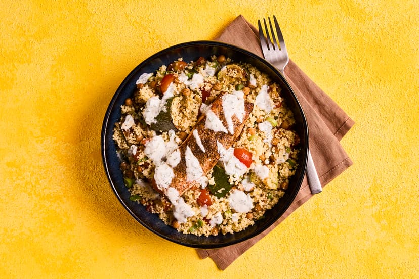 Preserved lemons are the secret ingredient in this dish. They’re chopped into couscous with fresh tomatoes, spring onion, roasted courgettes and chickpeas, topped with tender salmon baked in Moroccan spices, and finished off with minty yogurt and lemon wedges. Wow!