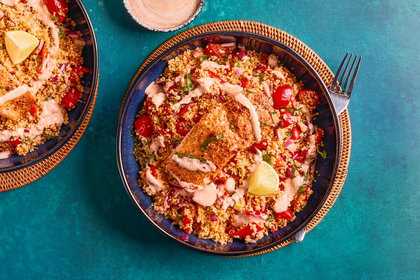 Prepare for a tastebud tingler! Salmon fillets are roasted in our special peri-peri spice blend and served with couscous packed with red pepper, tomato, onion, basil, garlic and chilli – with a cooling drizzle of yogurt and a spritz of lime.