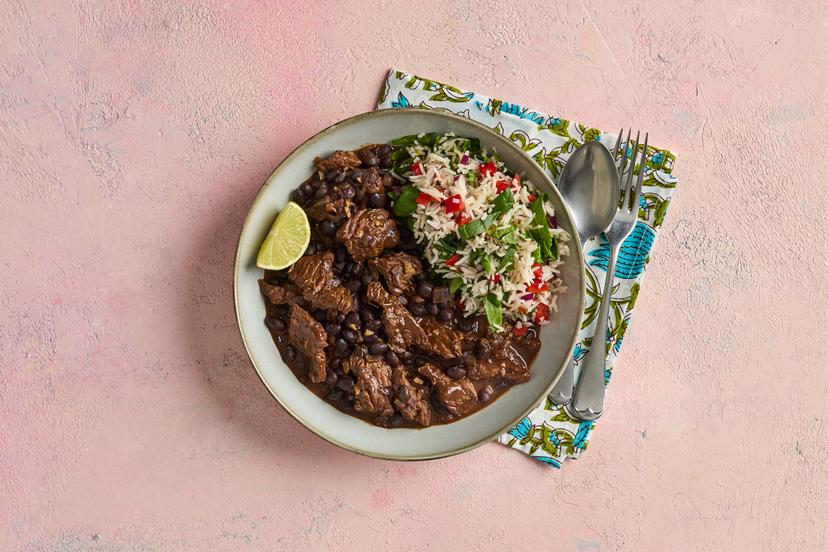 This simple dish combines juicy steak, black beans and warming Mexican spices for a rich, smoky-sweet flavour. Dolloped on top of basmati rice packed with spinach, red pepper and onion and pepped up with lime, it’s so good you might feel like starting a Mexican wave…