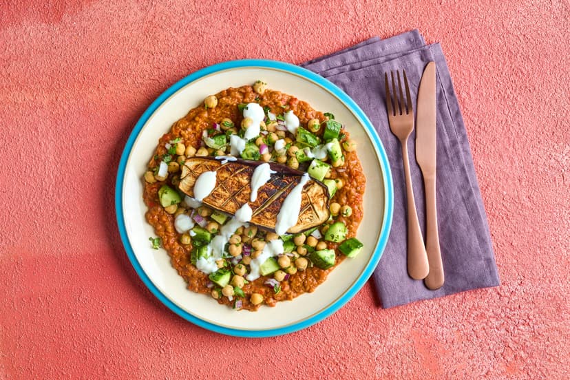 Squidgy roasted aubergine is served on a refreshing chickpea and cucumber salad and a showstopping pepper, butter bean and sumac base, made the easy-squeezy way courtesy of our Slimming World Kitchen garlic and sun-dried tomato pastes. Add cooling yogurt and you’ve got sunshine on a plate!