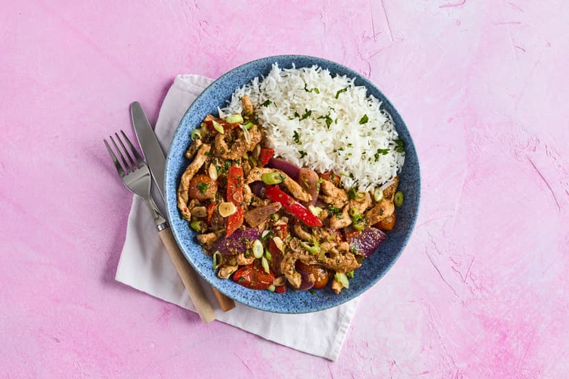 Inspired by Peru's staple dish, lomo saltado, this spectacular stir-fry features pork strips, sliced onion, red pepper and tomatoes, sizzled with a splash of balsamic vinegar and soy, and given a kick with chilli flakes, cumin and garlic. Served with fluffy basmati rice and sprinkled with fresh coriander and spring onions.