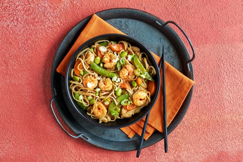 For this lightning-fast stir-fry, carrots, spring onions and sugar snaps are lightly sautéed, then simmered with plump prawns and edamame in a ginger, five-spice and soy sauce. Stir through slurpy rice noodles and there you have it – a mouth-watering masterpiece in just 20 minutes!