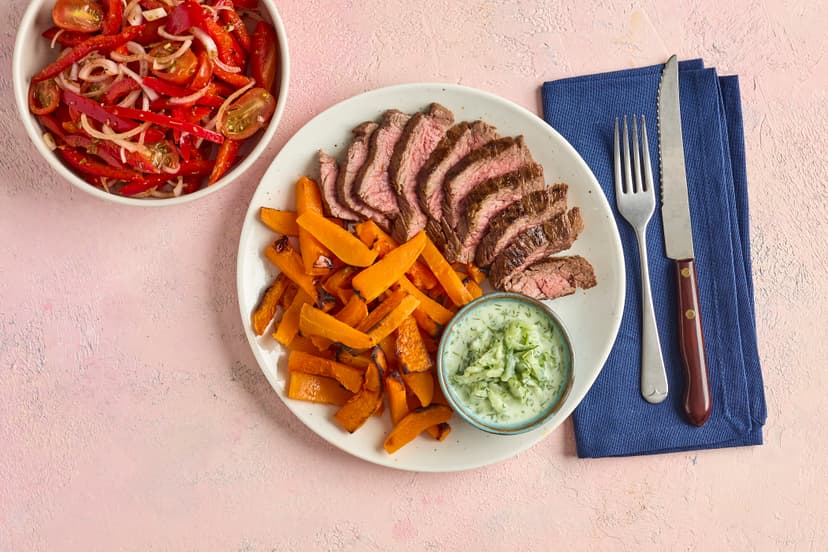 Satisfy the escapist in you with this sun-drenched steak dinner! Featuring bavette steaks infused with fresh lemon and sizzled with cumin seeds, butternut squash chips and a herby pepper, shallot and tomato salad, plus a tzatziki-style cucumber and dill dressing.