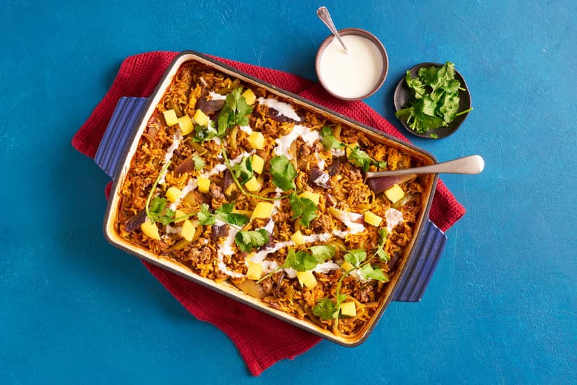 This one-dish wonder will transform your life – or at least, how you cook curry! Minced beef, onion and pepper chunks and basmati rice are oven-baked in a rich tomato curry sauce with fragrant mustard seeds, topped off with mango, yogurt and lime.