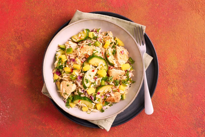 The perfect dish for a sunny day (or a rainy one, for that matter!), this super-fast warm salad zings with flavour. Sizzled chunks of chicken breast and spring onion join cucumber, onion, green pepper and rice in a zippy chilli lime dressing, finished with refreshing mango and a sprinkle of coriander.