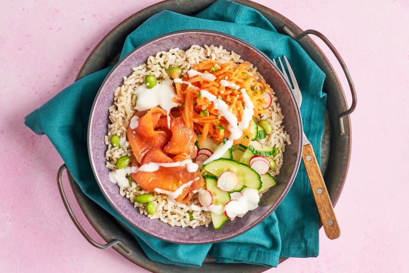 Succulent smoked salmon tastes even more sensational marinated in a punchy blend of ginger, garlic and tamari. Quick-pickled cucumber and radishes, a handful of grated carrot, a drizzle of Greek-style yogurt, chopped chilli and a base of edamame-packed brown rice complete the delicious picture. Eating healthy never tasted so good!