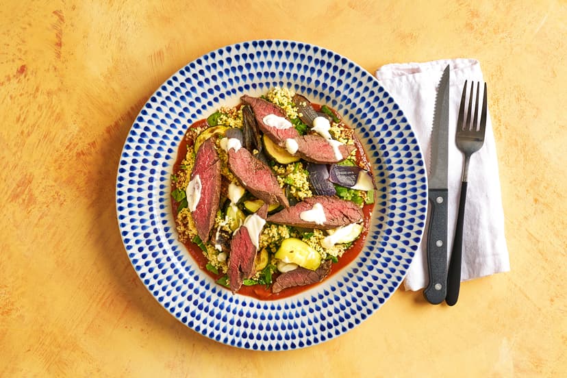 There’s layer upon layer of delight in this north-African inspired dish. First a richly spiced tomato sauce, then zesty couscous with mint and coriander, topped with grilled summer veg, juicy slices of bavette steak sizzled with more Moroccan spices, and finally a drizzle of yogurt.