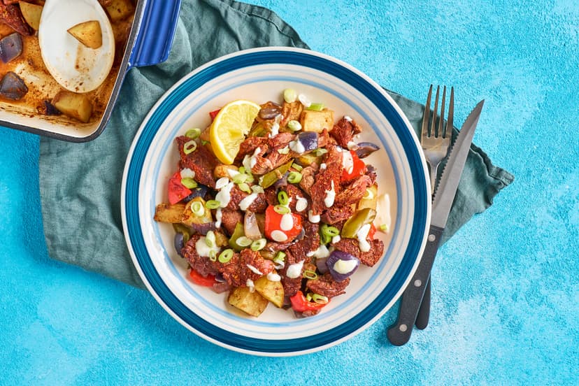 The oven does all the heavy lifting in this low effort, high impact dish. Diced potatoes, red pepper and onions are roasted with strips of bavette steak and a sprinkling of smoked paprika and oregano. A drizzle of garlicky yogurt, a scattering of spring onions and lemon finish it to perfection.