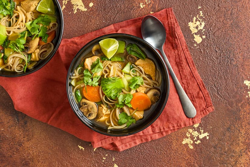 This light and zingy broth bowl is just the lift your day needs! Chicken chunks are stir-fried with spring onions, then simmered with pak choi, mushrooms and carrot in a stock souped up with tamari, ginger & garlic paste and aromatic lemongrass purée. Coriander, lashings of lime and oodles of noodles seal the deal.