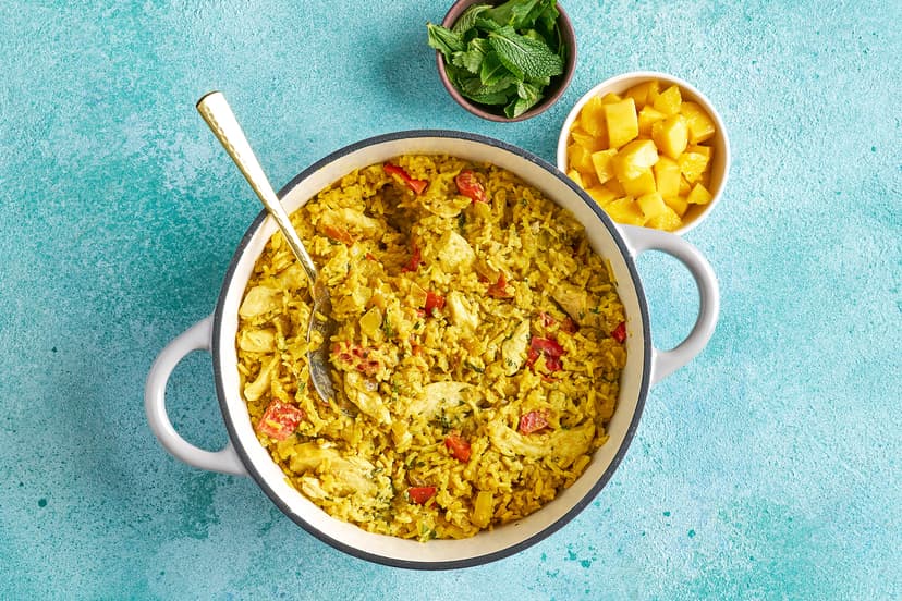 We love a kitchen hack, and this all-in-one way to cook up a mild chicken curry is a keeper! Onion, red pepper and baby tomatoes are softened with cumin seeds, curry powder and ginger. They’re simmered with basmati rice, sliced chicken breasts and exactly the right amount of stock, then finished with mint, diced mango and yogurt for your easiest curry ever.