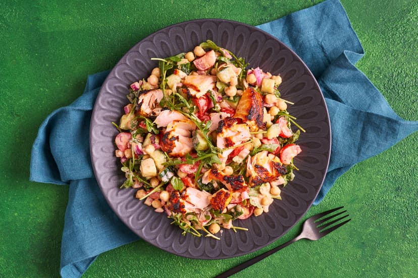 Dinner doesn’t get much faster, or tastier, than this! Salmon fillets are coated with spicy harissa paste and grilled. The chunky salad of chickpeas, red onion, tomato, cucumber and rocket, with lemon and harissa yogurt dressing, comes together in a flash. Twenty minutes later – eat and enjoy!