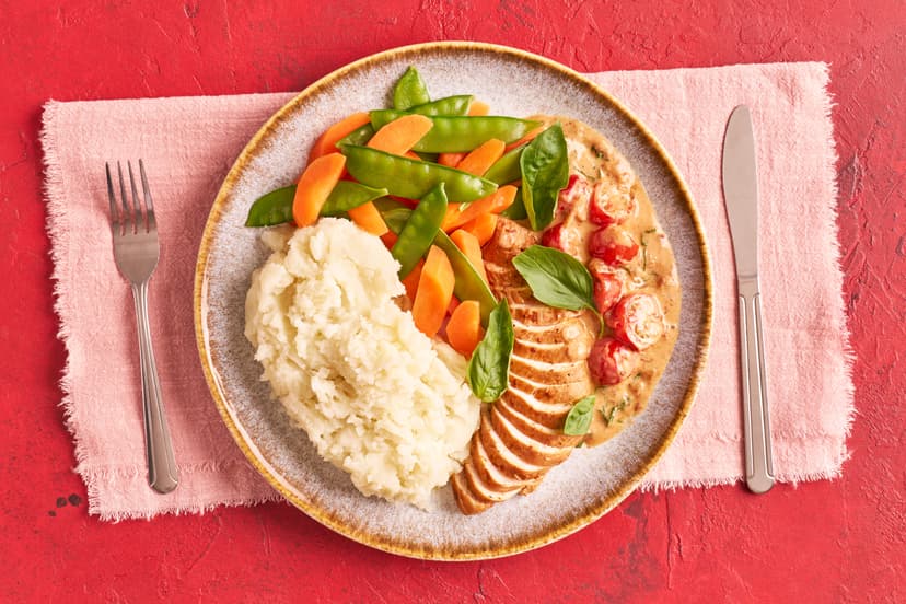 We’ve given chicken dinner a summertime glow-up!  Tender chicken breast is served simply with mangetout, carrots and potato mash, smothered in a sun-kissed tomato, shallot and basil sauce, creamy with Greek-style yogurt and sprinkled with basil. Winner, winner!