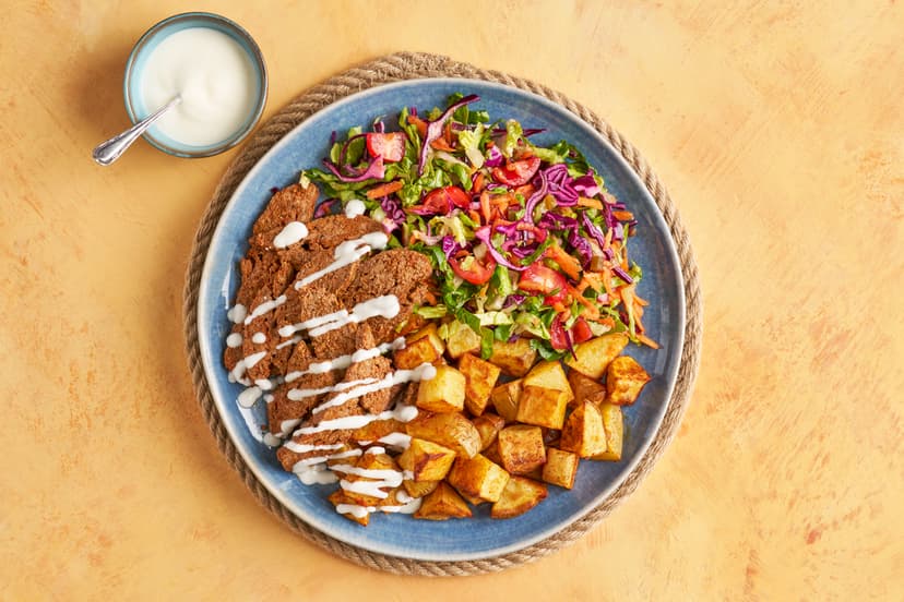 Love a kebab? We’ve got you… Spiced beef mince is pressed and baked, then sliced into juicy strips. Add the classic trimmings (jalapeños, red cabbage, salad), a drizzle of yogurt and a generous side of mini roasted potatoes and you’ve ‘gone for a doner’ without leaving the house!