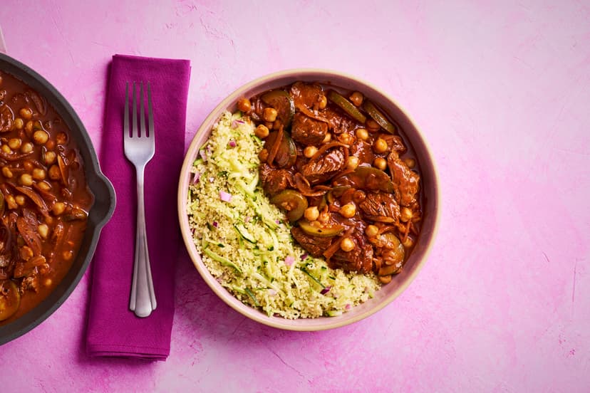 Tagines normally take their sweet time, but thanks to easy-squeezy harissa and ginger & garlic pastes, and a ready-blended spice mix, this North African-style feast is on the table in just 20 mins. Tender bavette steak keeps the simmer time short, while chickpeas and onion and courgette-packed couscous soak up all that rich, fragrant flavour.