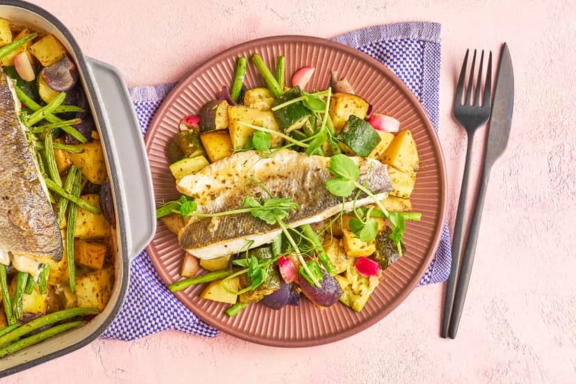 There’s nothing ‘bung it in’ about this traybake, it’s got big, bougie bistro dreams! It starts with a bed of Parmentier-style potatoes, roasted with courgette, red onion, lemon zest and oregano. Then comes rich, herby stock, a scatter of radishes and green beans, and sea bass fillets cooked till crispy skinned and tender. Finish fancy with a handful of pea shoots and a chef’s kiss.