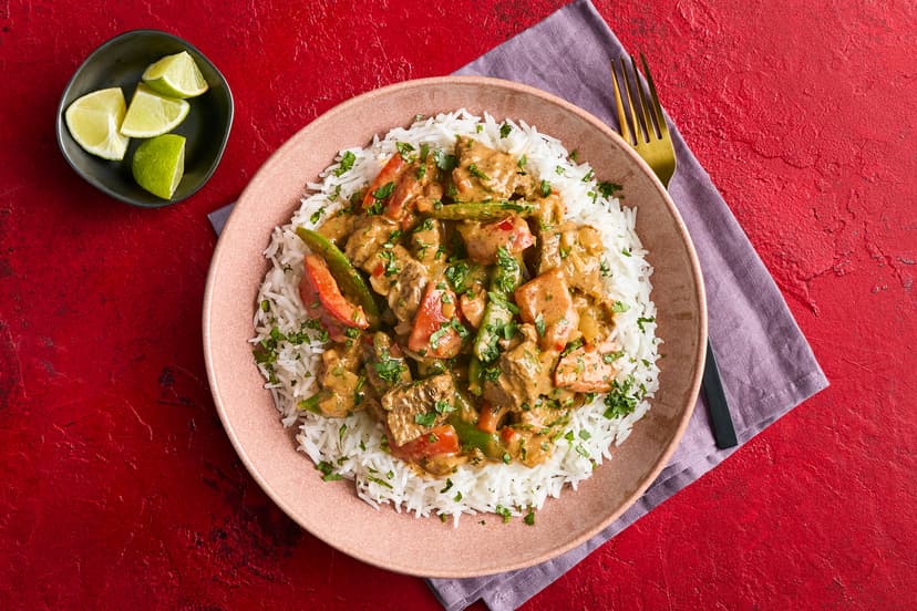 Tender chunks of steak are sizzled with onion, pepper and sugar snaps in a spicy red Thai curry sauce, served with basmati rice and a sprinkle of lime and coriander. For flavour and filling power, it beats a takeout hands down!