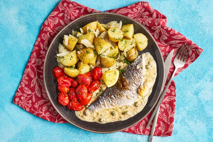 This swish fish dish has serious flair. Crispy-skinned sea bass fillets and grilled baby tomatoes are served on a creamy caper, shallot and wholegrain mustard sauce with fennel-infused baby potatoes, all scattered with fresh dill.