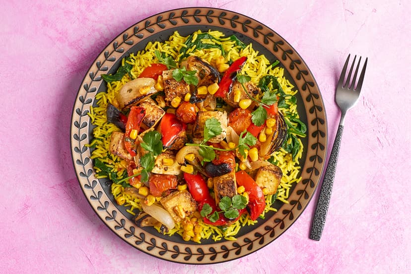 Colourful, crave-worthy and quick! Our new grilled tofu dish brings together charred corn, red pepper, onion and baby tomatoes sprinkled with peri-peri seasoning, all served with vibrant turmeric and spinach rice. A quick win – and an absolute triumph.